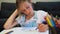 Young schoolgirl drawing eye at home.