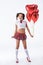 young schoolgirl with helium balloons in shape of hearts