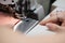 A young schoolgirl learns to sew face masks during a pandemic on an overlock sewing machine