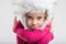 Young schoolgirl wearing fluffy cap making face