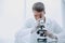 Young scientist with a microscope sitting at a laboratory table