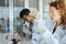 Young scientist researcher examining chemical liquid in test tube in modern laboratory. Science and medicine concept