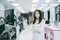 Young  scientist in white lab coat standing with automation blood analyzer at medical laboratory