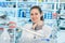 Young scientist woman in a chemistry lab looking at the camera