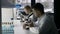 Young scientists studying substance in microscope