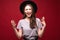 Young scream woman with black hat standing on red background