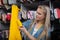 A young seamstress selects threads for the chosen yellow fabric.