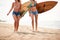 Young seductive female surfers on a beach