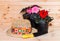 Young seedling begonia flowers and hat on wooden background