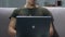 Young sergeant working laptop closeup, searching information online, application