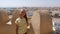 Young serious girl standing on top tower of fortress