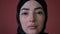Young serious and upset Muslim woman in hijab having problem and stress. Worried middle eastern arabian religious woman