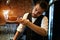 Young serious waiter checking a cup of tea before serving it to clients