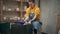 Young serious woman in an apron making ceramic pottery on the wheel