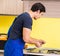 Young service contractor assembling kitchen furniture