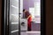 young serviceman checks broken washing machine loader on floor in room closeup