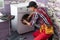 young serviceman checks broken washing machine loader on floor in room closeup