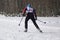 Young sexy blonde with skis. Mountain-skier.Studio. Brick background