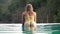 Young sexy woman in bikini in the outdoor swimming pool. Beautiful girl in pool