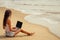 Young sexy woman in stylish glasses using laptop freelancing on the tropical paradise beach. Girl freelancer work