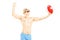 Young shirtless man playing with a beach ball