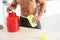 Young shirtless  man preparing protein shake in kitchen, closeup view