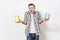 Young shocked man in casual clothes holding empty paint tin cans with copy space isolated on white background