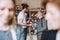 Young shop assistant serving a senior man in a zero waste shop.