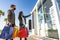 Young shopaholic couple in Coronavirus protection mask looking shop window sale offers. Young customer woman pointing finger to