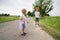 Young siblings playing on country road