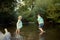 Young siblings playing in river