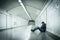 Young sick man lost suffering depression sitting on ground street subway tunnel