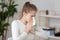 Young sick woman holding handkerchief sneezing indoors