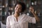 Young sincere african american woman showing keys to camera.