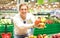 Young single man showing fruit and vegetables at shopping in grocery store supermarket - Modern healthy lifestyle concept concept