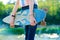 Young skateboard girl holding her longboard outdoors on sunset