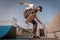 Young skateboarder falling off the board after doing a trick. General plane