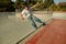 Young skateboarder flies with his board on the ramp of a skate park