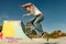 Young skateboarder flies with his board on the ramp of a skate park