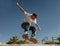 Young skateboarder flies with his board on the ramp of a skate park