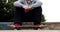 Young skateboarder sitting at the outdoor skatepark