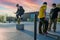 Young skateboarders jumping over stone cubes in the square of peace in Wroclaw.