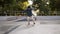 Young skater in casual clothes and black hat sliding from the ramp and making flip trick with board unsuccessfully in