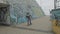 Young skaters riding down descent to underpass