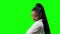 Young Skeptic African American Black Woman turn around on a green background