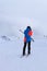 Young skier puts on goggles for better visibility in poor conditions on the piste located on the border between Italy and Austria