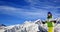 Young skier with on snow mountains at sun winter day