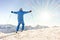 Young skier at the top of mountain raising arms at sky for goal achieved - Sporty man enjoying skiing day with sun light in