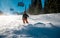 Young skier turning during windy conditions on slope