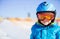 Young skier wearing safety helmet and goggles